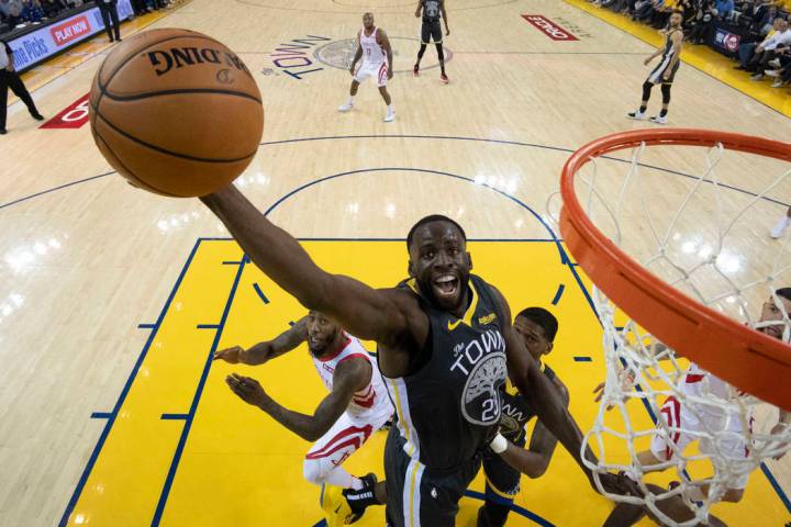 Golden State Warriors forward Draymond Green (23) grabs a rebound against the Houston Rockets d ...