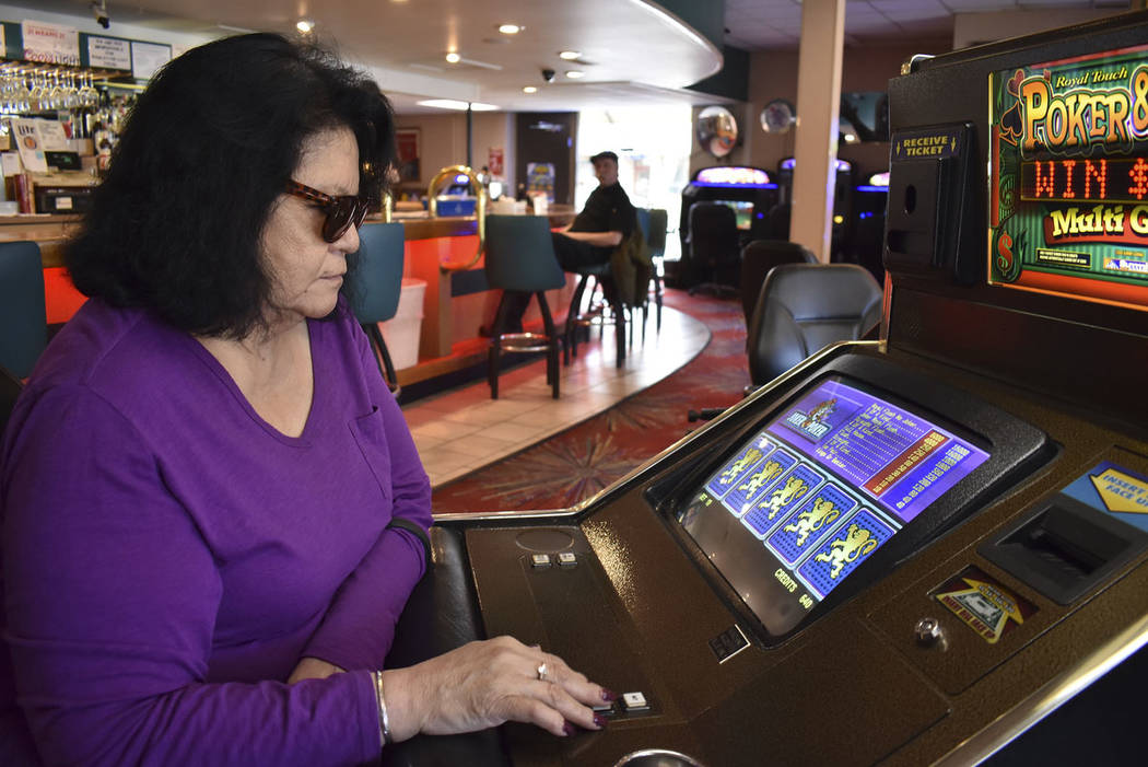 Lucille Brien plays a video poker machine at the Monte Bar and Casino in Billings, Montana, Tue ...