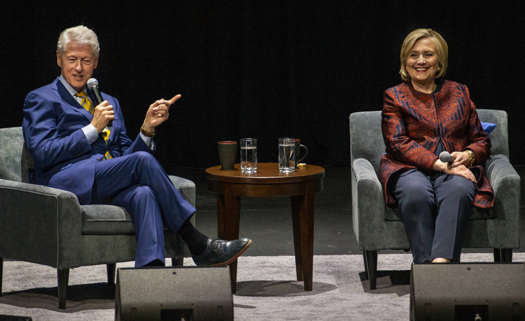 Former U.S. President Bill Clinton answers a question beside former U.S. Secretary of State Hil ...