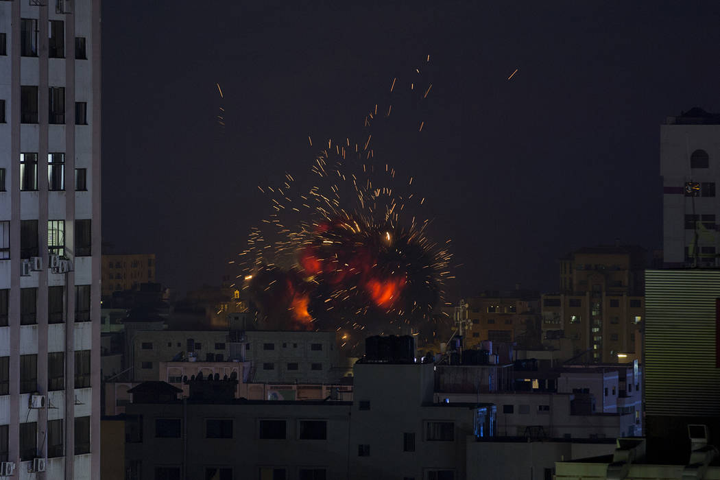 An explosion caused by an Israeli airstrike on a building in Gaza City, Saturday, May 4, 2019. ...