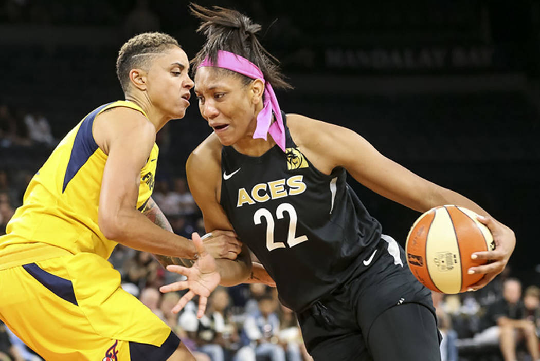 Las Vegas Aces center A'ja Wilson (22) drives the ball against Indiana Fever forward Candice Du ...