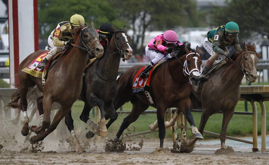 Flavien Prat on Country House, left, races against Luis Saez on Maximum Security, second from r ...