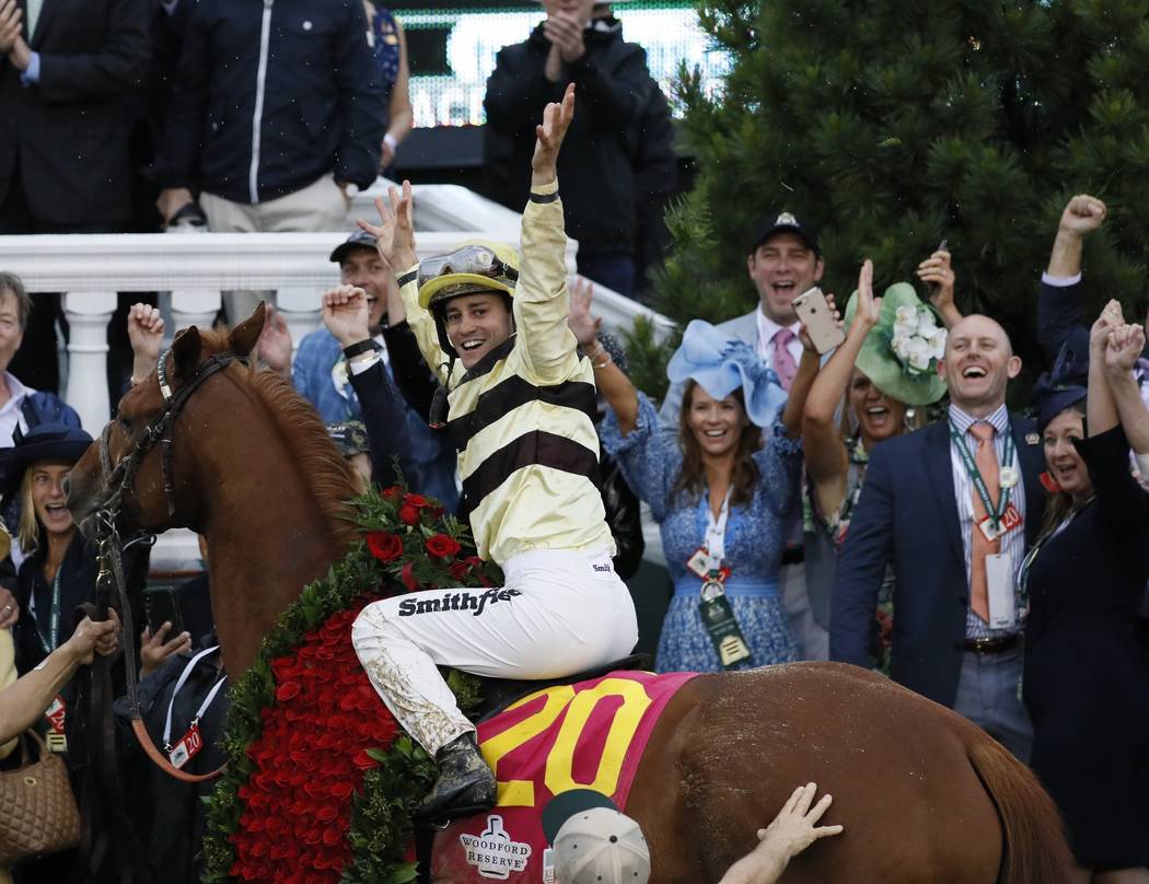 Flavien Prat celebrates after riding Country House to victory during the 145th running of the K ...