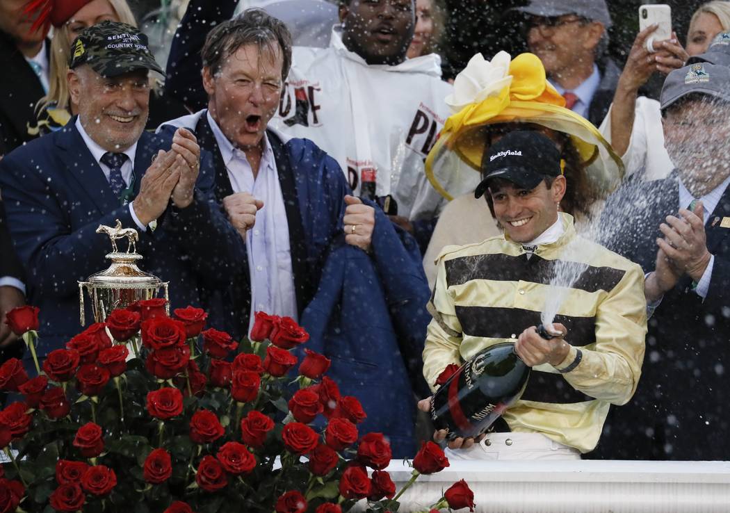 Flavien Prat celebrates after riding Country House to victory during the 145th running of the K ...