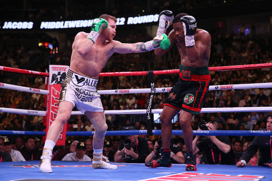 Saul Canelo Alvarez, left, battles Daniel Jacobs in the WBC, WBA, IBF, and Ring middleweight ti ...