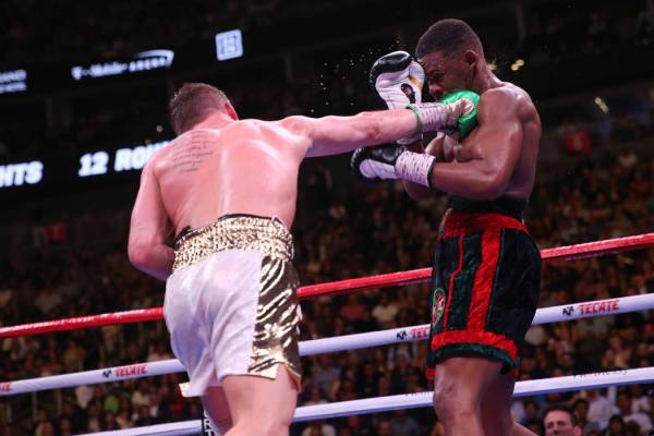 Saul “Canelo” Alvarez, left, connects a punch against Daniel Jacobs in the WBC, W ...