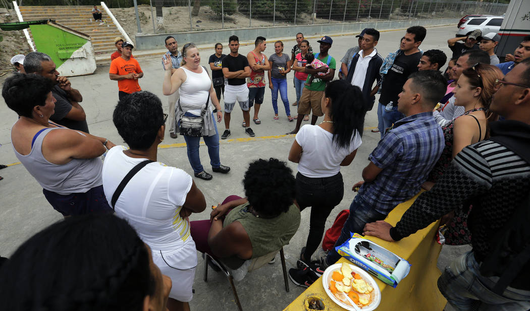 In this Tuesday, April 30, 2019, photo, attorney Jodi Goodwin, center, speaks to migrants seeki ...