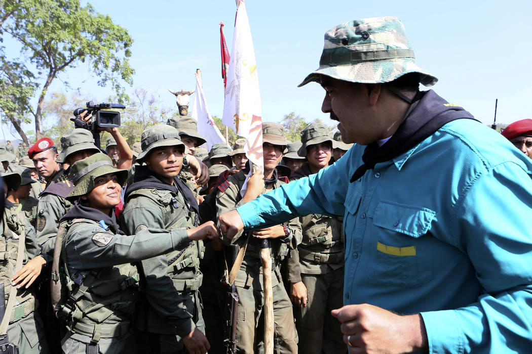 In this handout photo released by Miraflores Press Office, Venezuela's President Nicolas Maduro ...