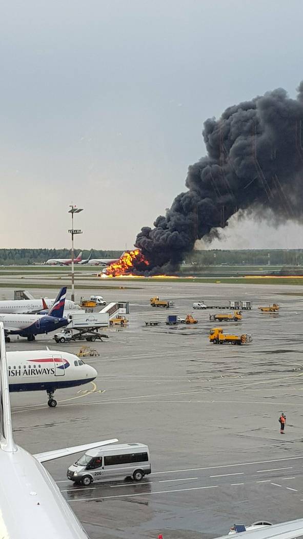 In this image provided by Riccardo Dalla Francesca shows smoke rises from a fire on a plane at ...