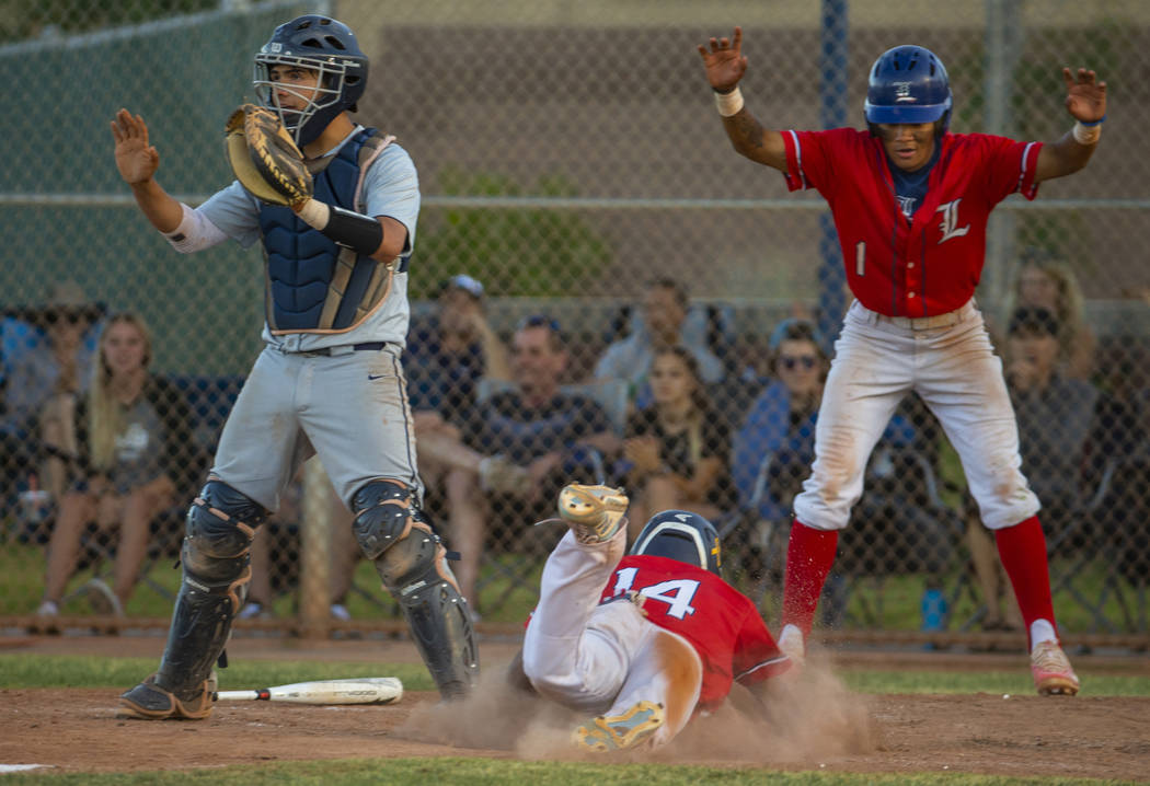 Spring Valley catcher Ryan Steinhauer (24) waits for a late throw as Liberty's Ryan Towers (14) ...