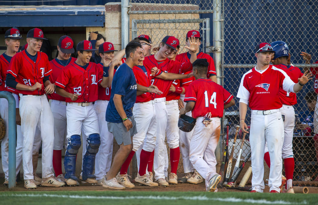 Liberty players celebrate a late-game score by teammate Ryan Towers (14) during the first round ...