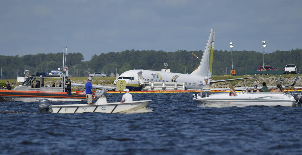 A charter plane carrying 143 people and traveling from Cuba to north Florida sits in a river at ...