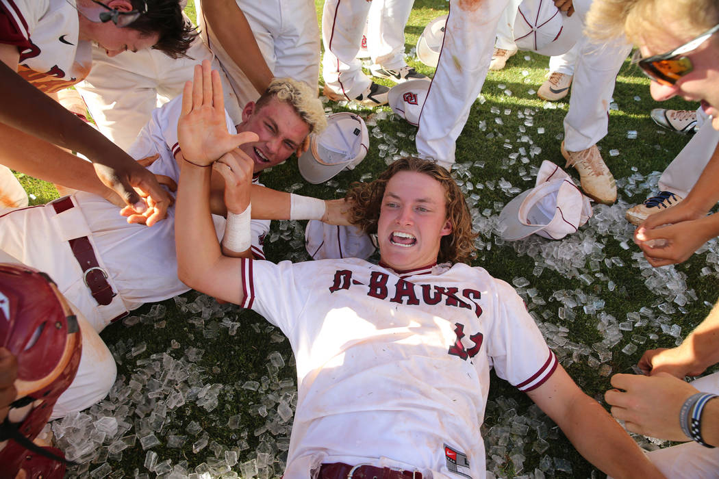 Desert Oasis' pitcher Josh Sharman (11) celebrates a win with his team over Basic in the Desert ...