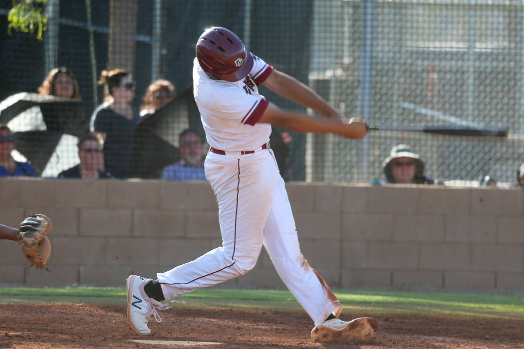 Desert Oasis' Aaron Roberts (25) swings for a three run homer against Basic in the Desert Regio ...