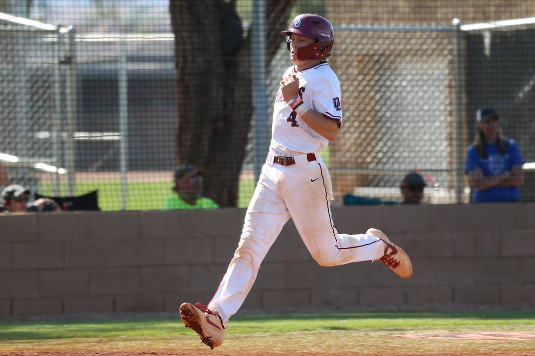 Desert Oasis' Parker Schmidt (4) runs home for a run against Basic in the Desert Region champio ...