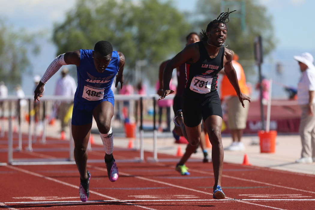 Desert Pines' Jamel Brown (482), left, wins first place in the Mountain Region boys 110 meter h ...