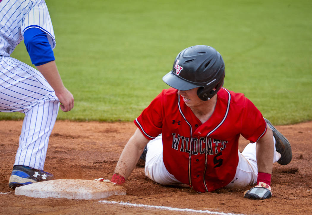 Las Vegas' Joel Lindahl (5) dives back to first base to beat the tag versus Reno during their s ...