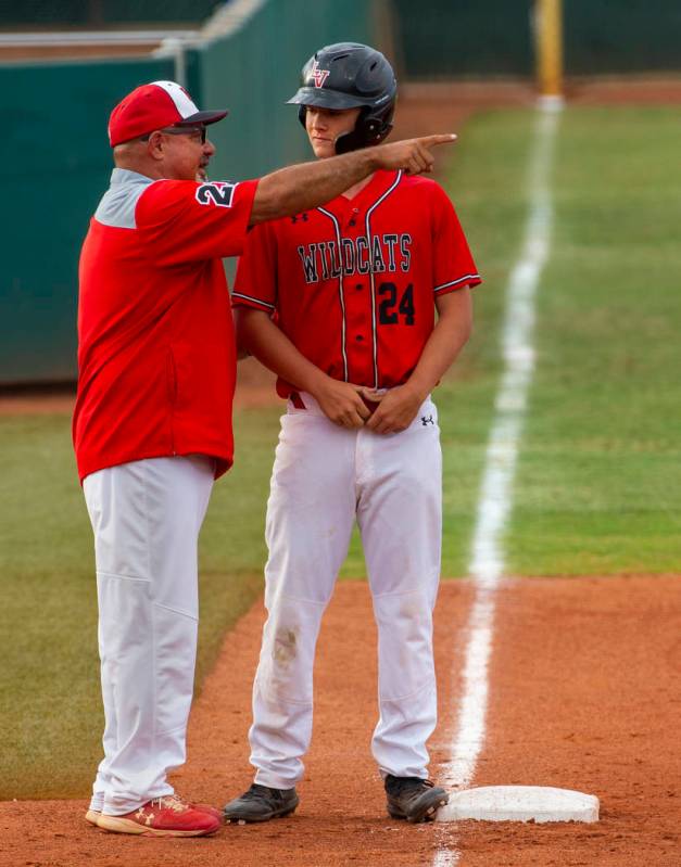 Las Vegas head coach Sam Thomas counsels his runner Brady O'jeda (24) at third base versus Reno ...