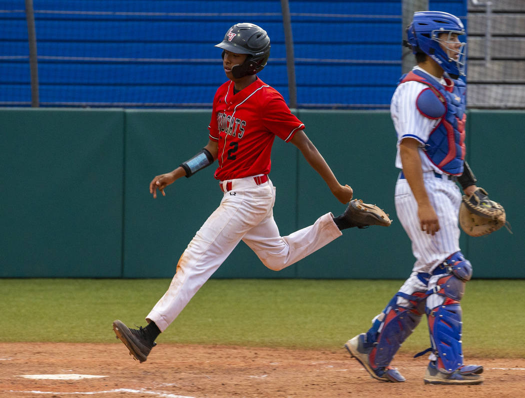 Las Vegas' Martin Simmons (2) scores past Reno's Lane Oliphant (28) during their state baseball ...