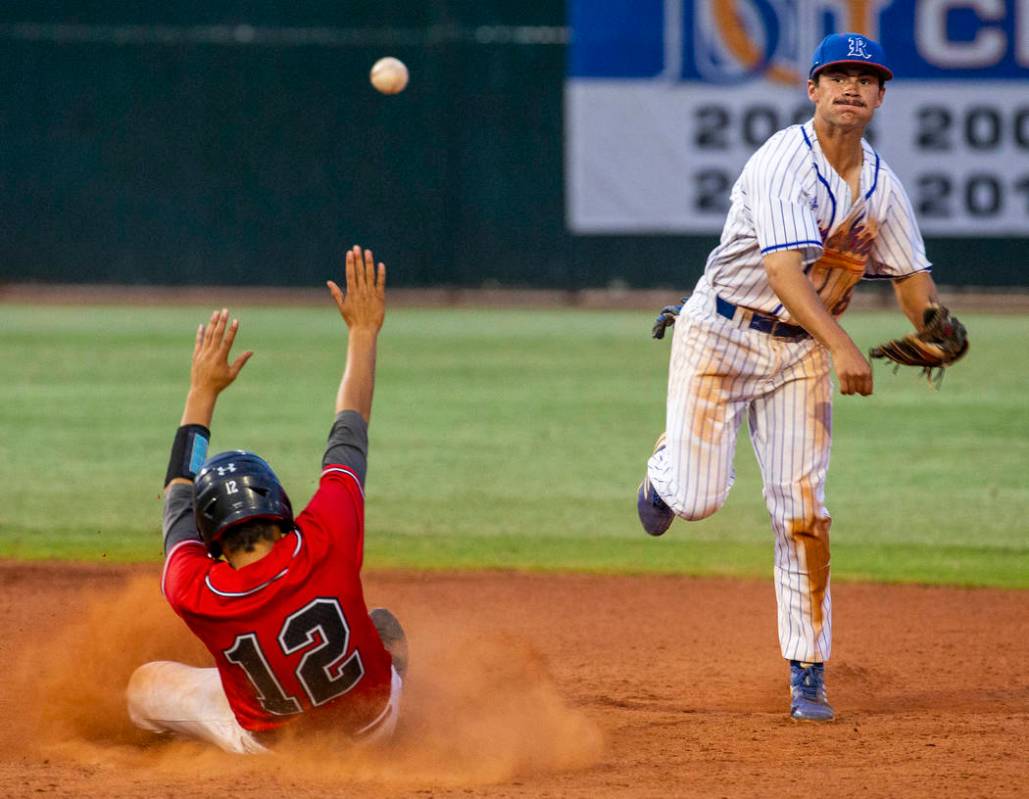 Las Vegas' Nathan Freimuth (12) slides late into second base as Reno's Gunner Gouldsmith (8) lo ...