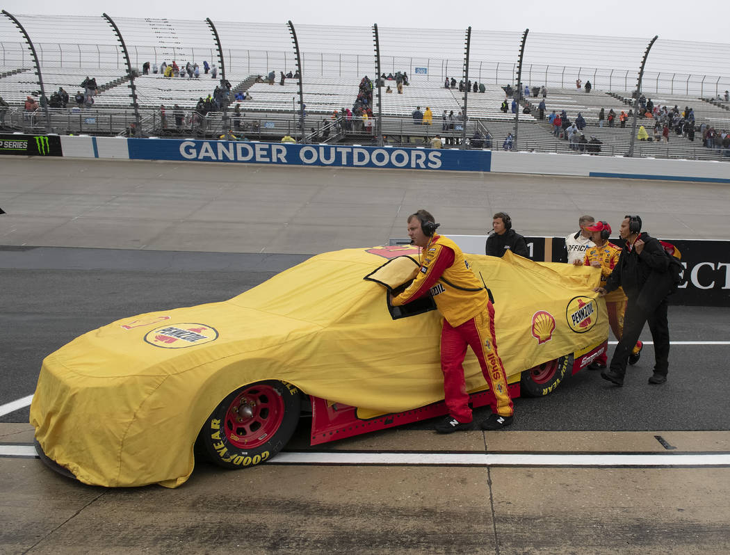 The team of Joey Logano pushes his car off of pit road after a NASCAR Cup Series auto race was ...