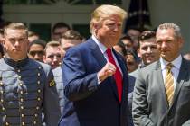 President Donald Trump pumps his fist as he departs after the presentation of the Commander-in- ...