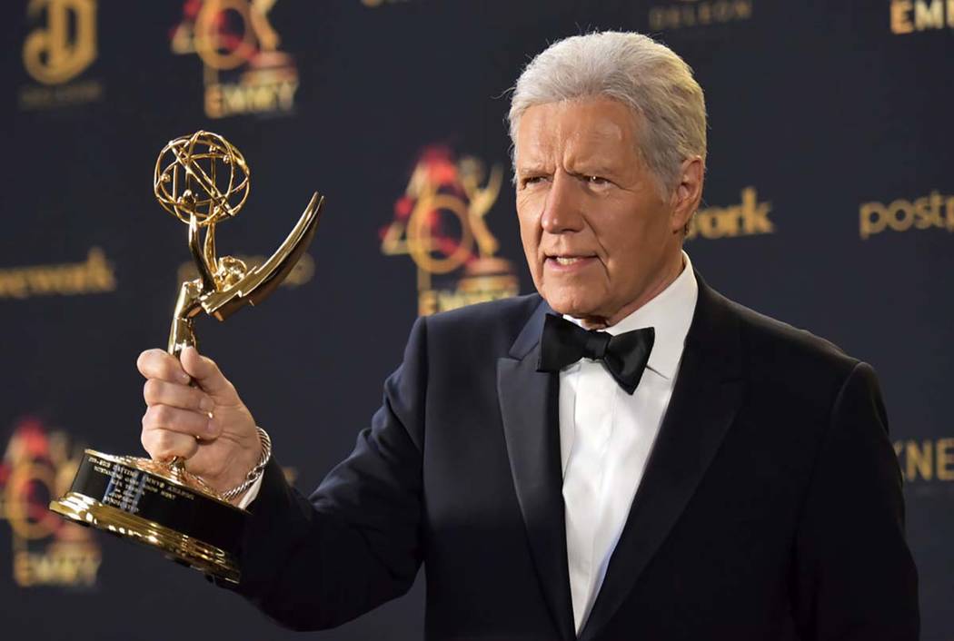 Alex Trebek poses in the press room with the award for outstanding game show host for "Jeopardy ...