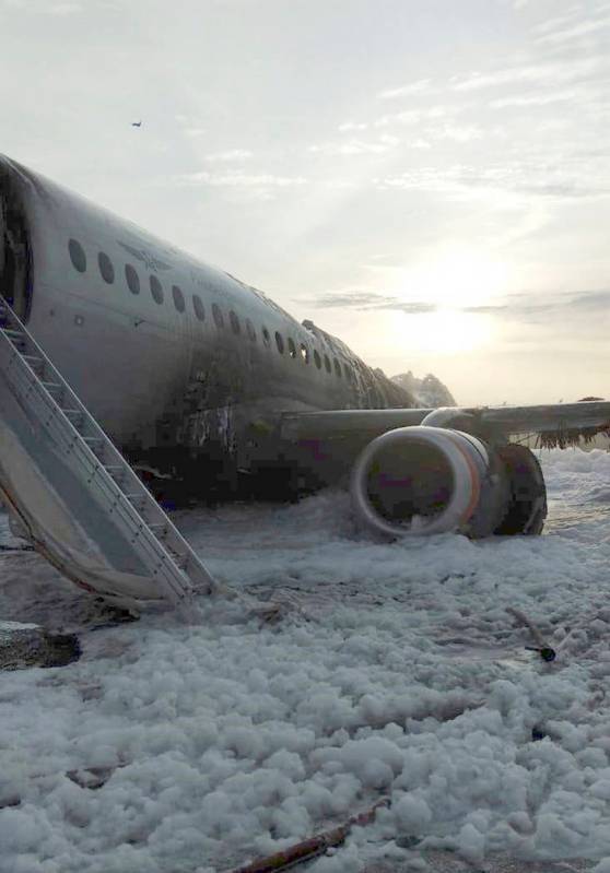 The Sukhoi Superjet 100 aircraft of Aeroflot Airlines is covered in fire retardant foam after a ...