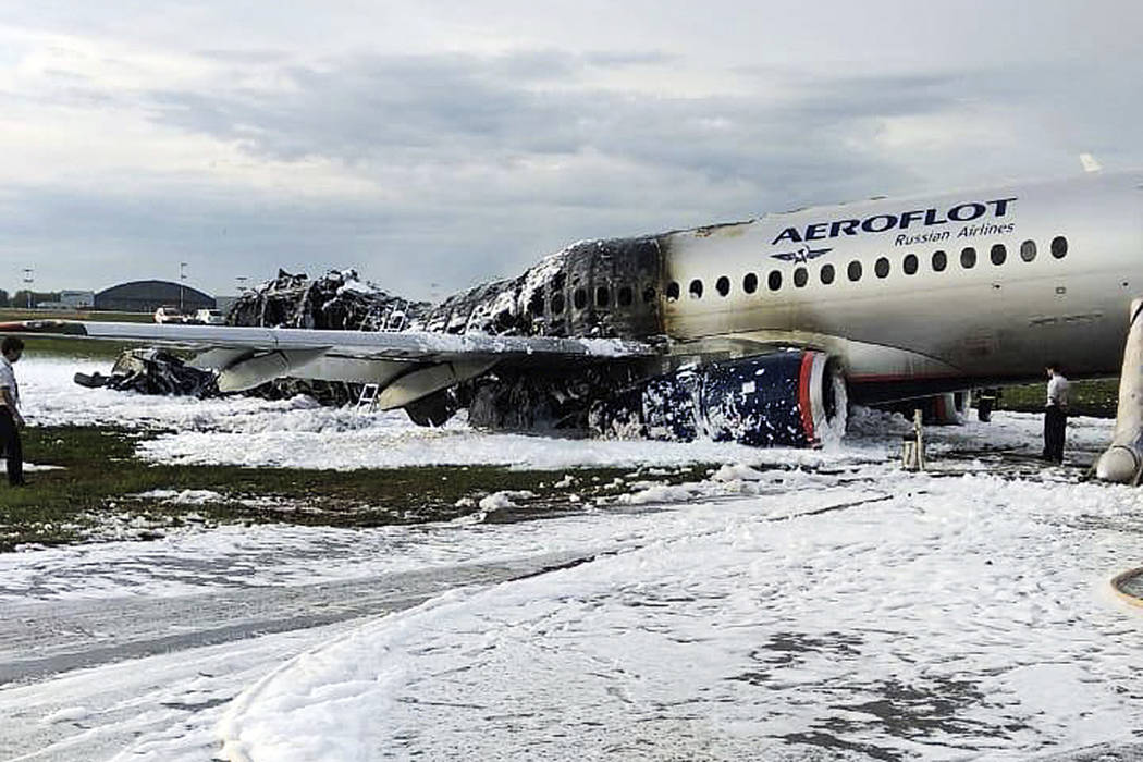 The Sukhoi SSJ100 aircraft of Aeroflot airlines is covered in fire retardant foam after an emer ...