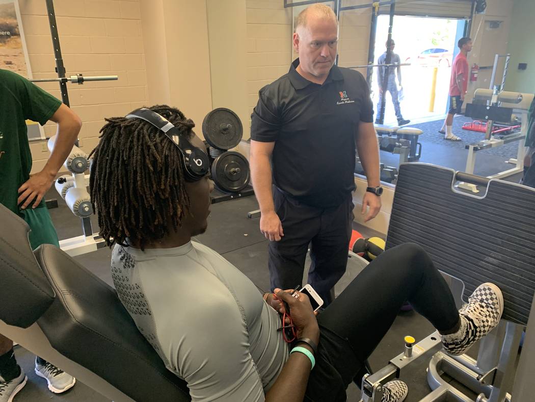 Jeffrey Taormina works with a student athlete during his physical therapy class on May 2.(Mia S ...