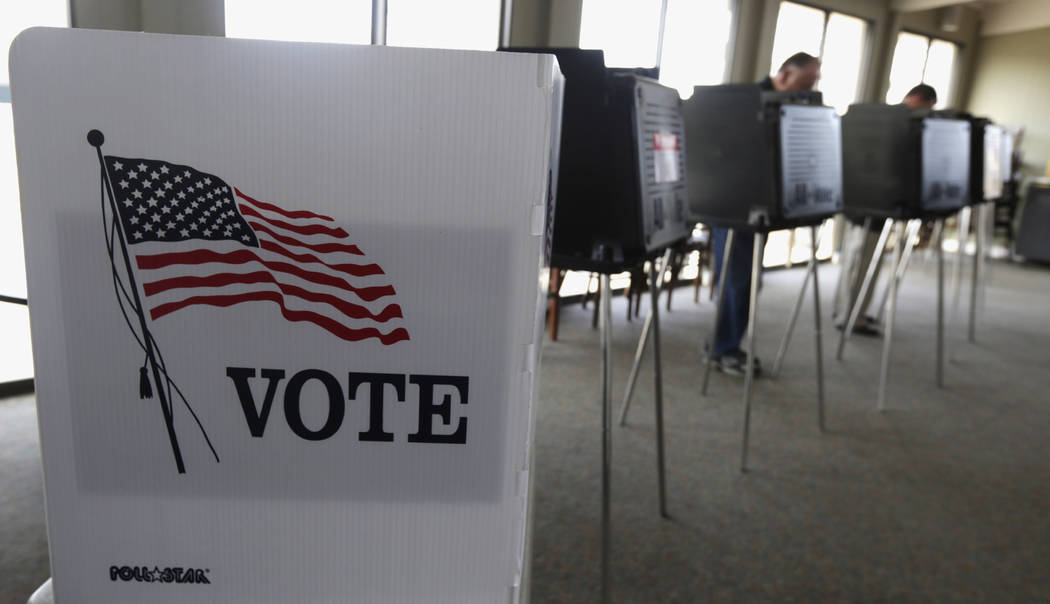 FILE - In this March 18, 2014 file photo, voters cast their ballots in Hinsdale, Ill. Microsoft ...