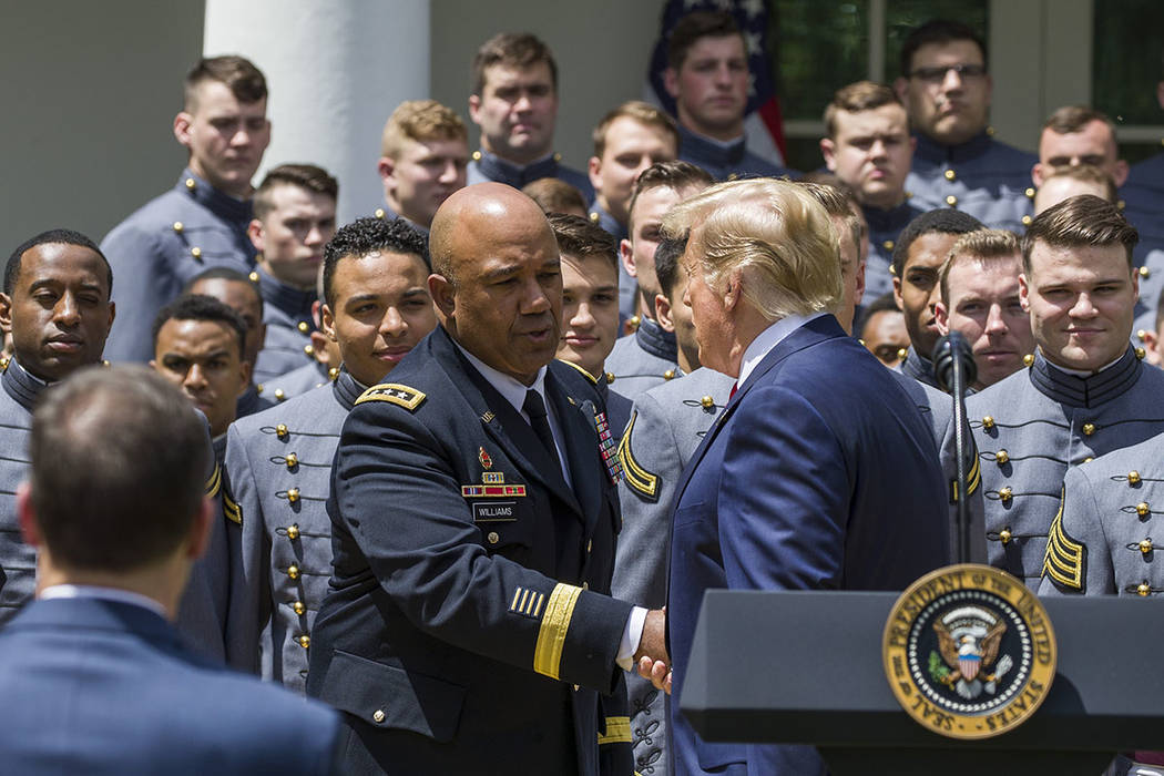 West Point Superintendent Lt. Gen. Darryl Williams, center, shakes hands with President Donald ...