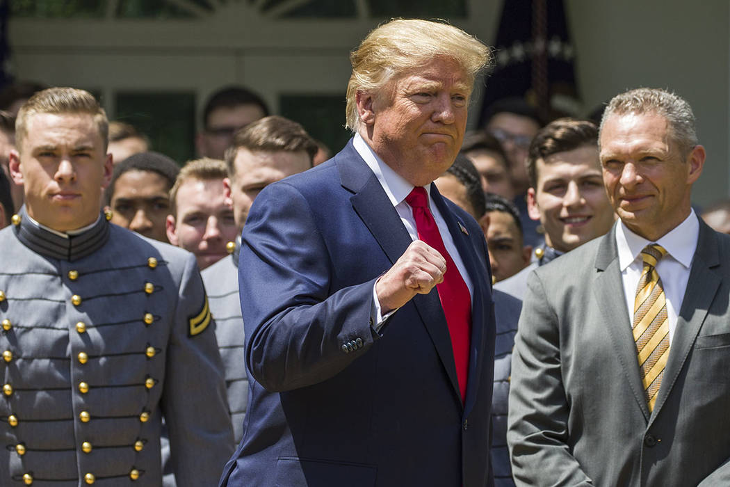 President Donald Trump pumps his fist as he departs after the presentation of the Commander-in- ...