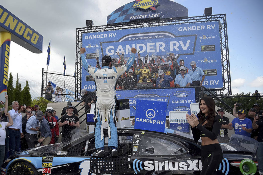 Driver Martin Truex Jr. (19) celebrates with his team after winning the NASCAR Cup Series auto ...