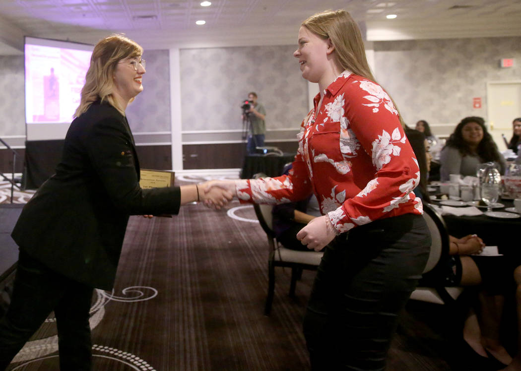 Caitlin Gaddis of the Spring Valley High School newspaper, The Grizzly Growler, right, receives ...