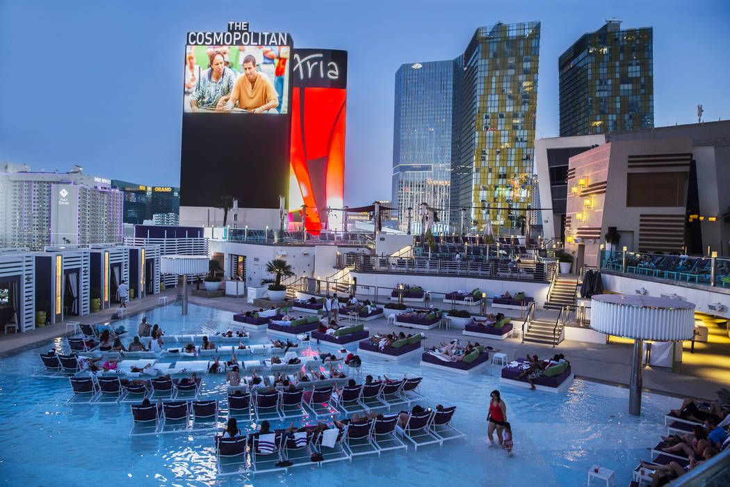 Pool goers enjoy a showing of Happy Gilmore during Dive in Movies at Boulevard Pool on Monday, ...