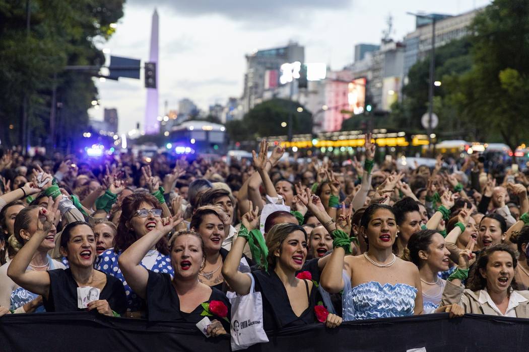 Women dressed as Eva Peron parade down the streets of Buenos Aires, Argentina, Monday, May. 6, ...