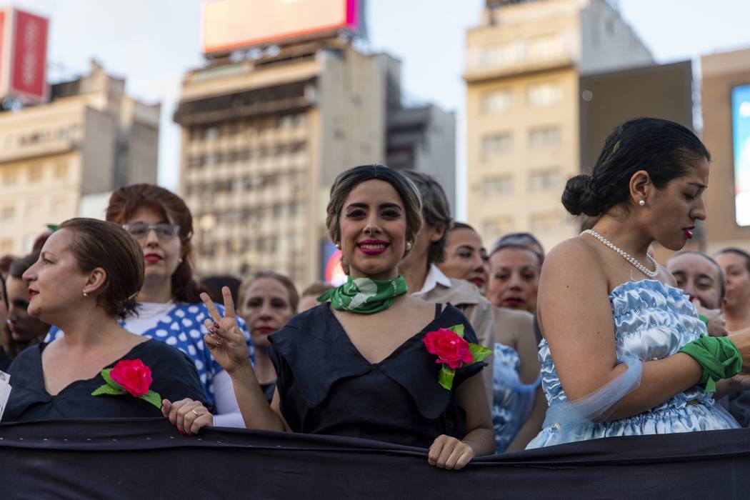 Women dressed as Eva Peron parade down the streets of Buenos Aires, Argentina, Monday, May. 6, ...