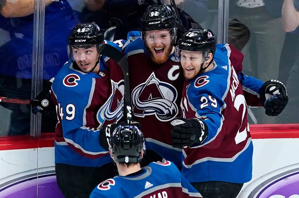 Colorado Avalanche left wing Gabriel Landeskog (92) is congratulated by teammates Samuel Girard ...