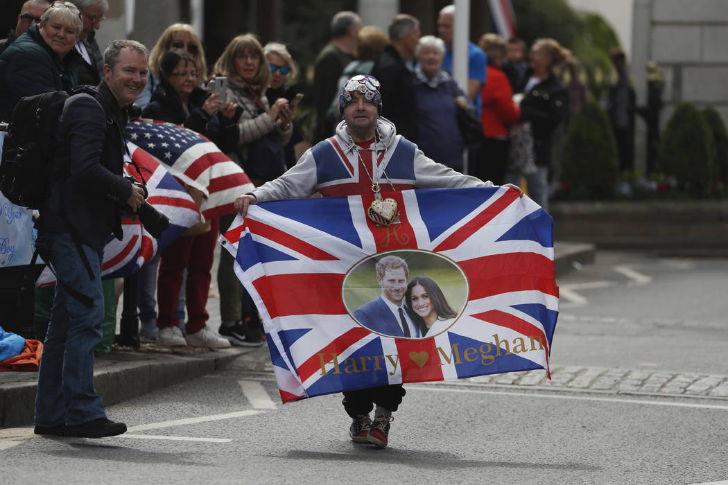 Royal fan John Loughery displays a banner as people wait for the Royal Regiment of Scotland ban ...