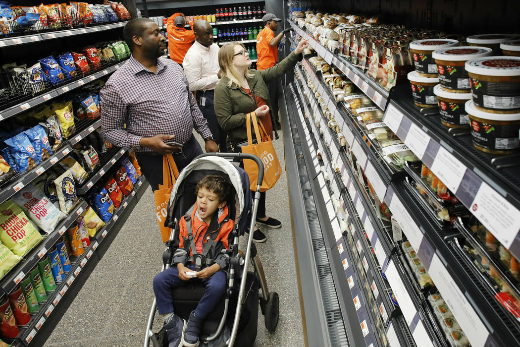 Customers shop in a newly-opened Amazon Go store, Tuesday, May 7, 2019 in New York. The store w ...