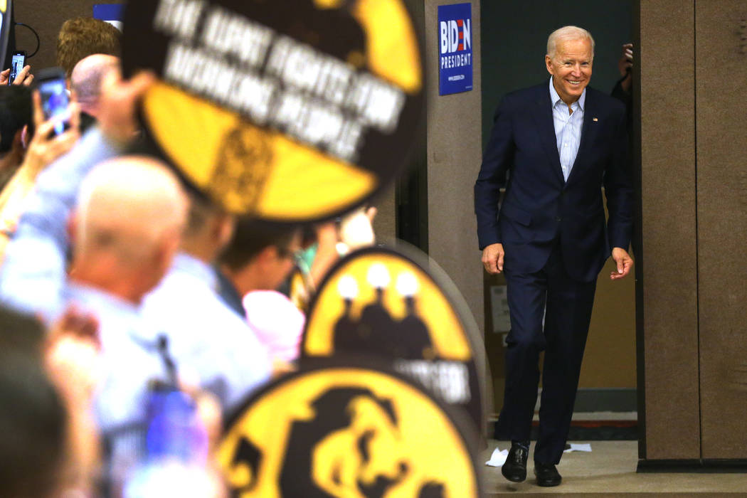 Democratic presidential candidate Joe Biden speaks enters the room for a campaign stop at the I ...
