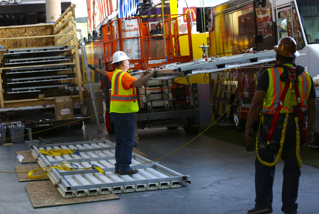 Construction workers prepare to installl a new panel during the second day of renovations of th ...