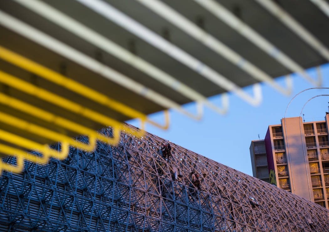 Construction workers work around the exterior of the canopy during the second day of renovation ...