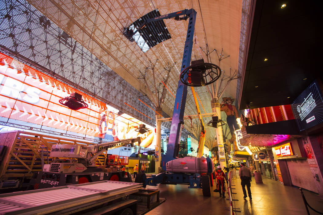 Construction workers prepare to installl a new panel during the second day of renovations of th ...