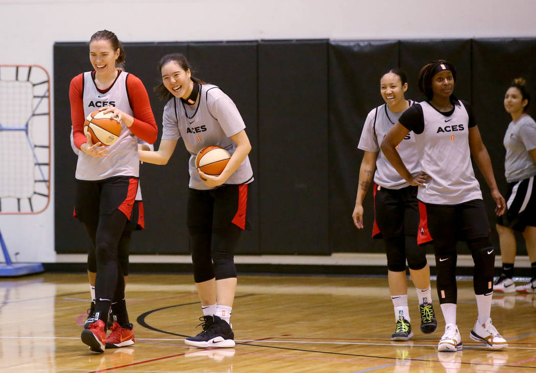 Aces center Ruth Hamblin, left, jokes with teammates, from second from left, JiSu Park, Saniya ...