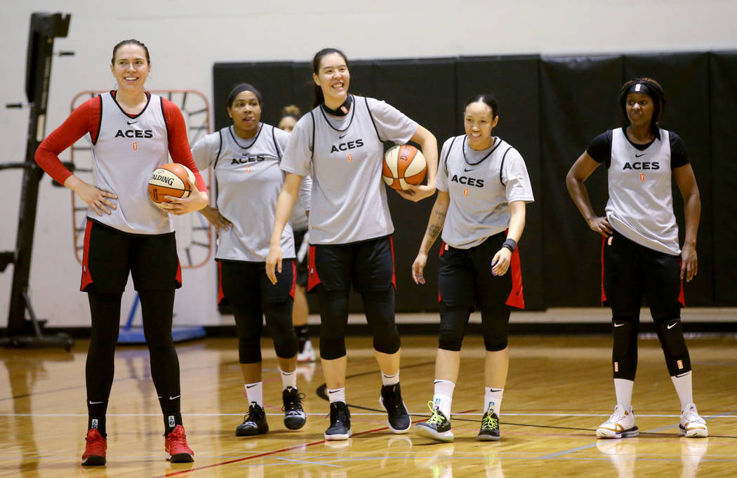 Aces center Ruth Hamblin, left, with teammates, from second from left, Alex Harden, JiSu Park, ...