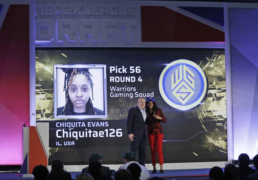 Chiquita Evans poses for photographs with Brendan Donohue after being selected as the 56th pick ...