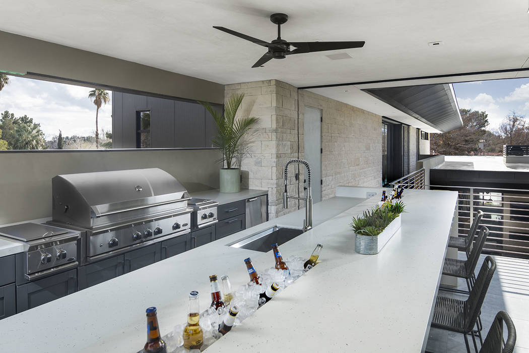 A good place to grill for company is the second-story outdoor kitchen. (Studio G Architecture)