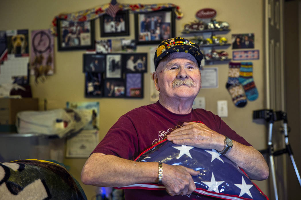 Ret. Chief Master Sgt. Clifford Smith, a Vietnam War veteran, holds a military burial flag in h ...